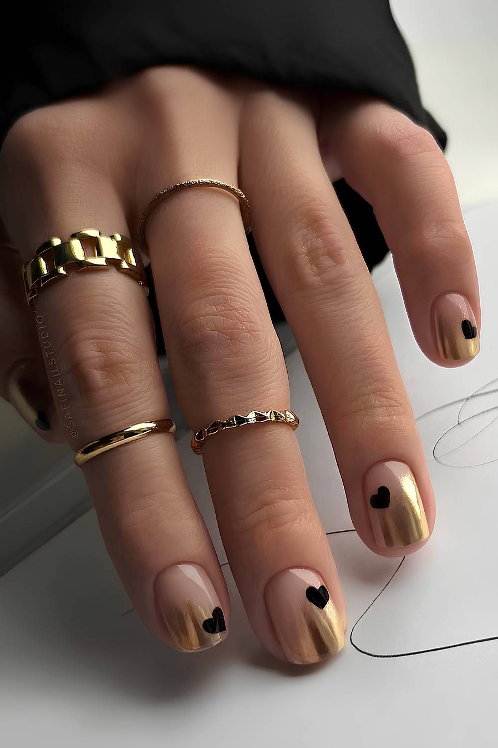 Gold ombre nails with black heart art