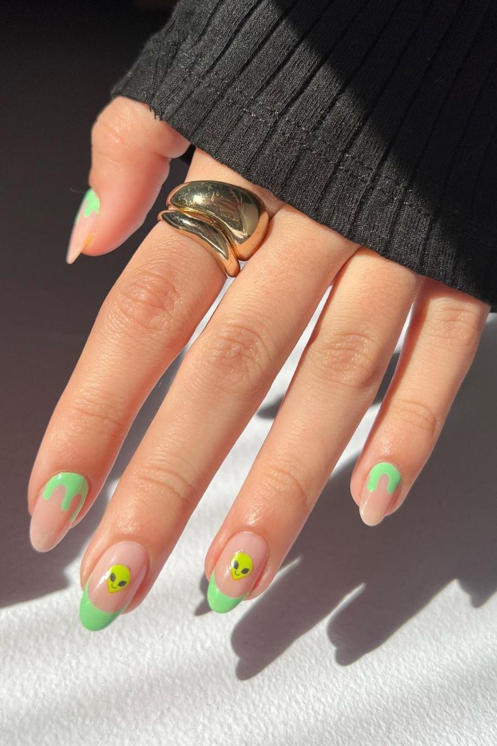 Green french tip nails with alien accents