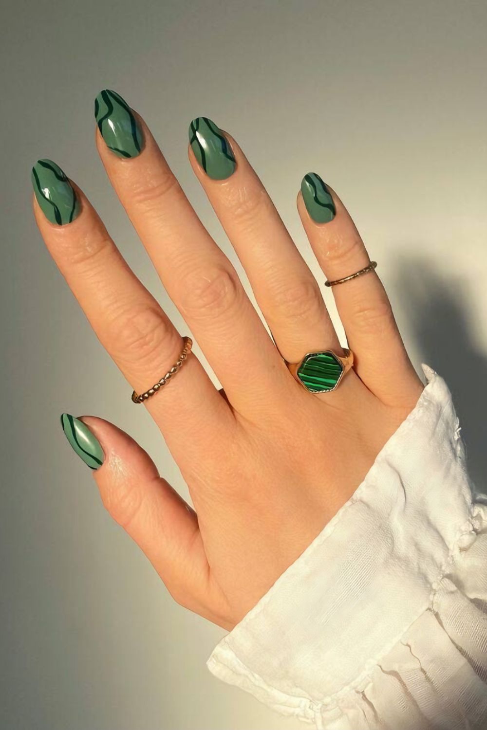 Green nails with abstract black lines