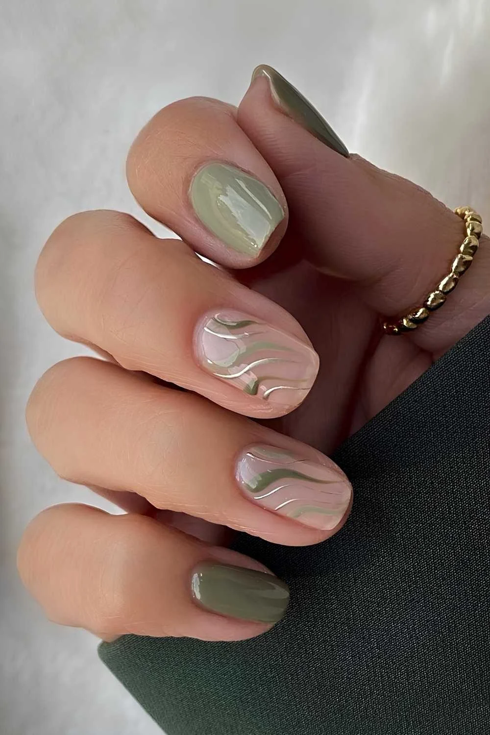 Green nails with silver chrome line art