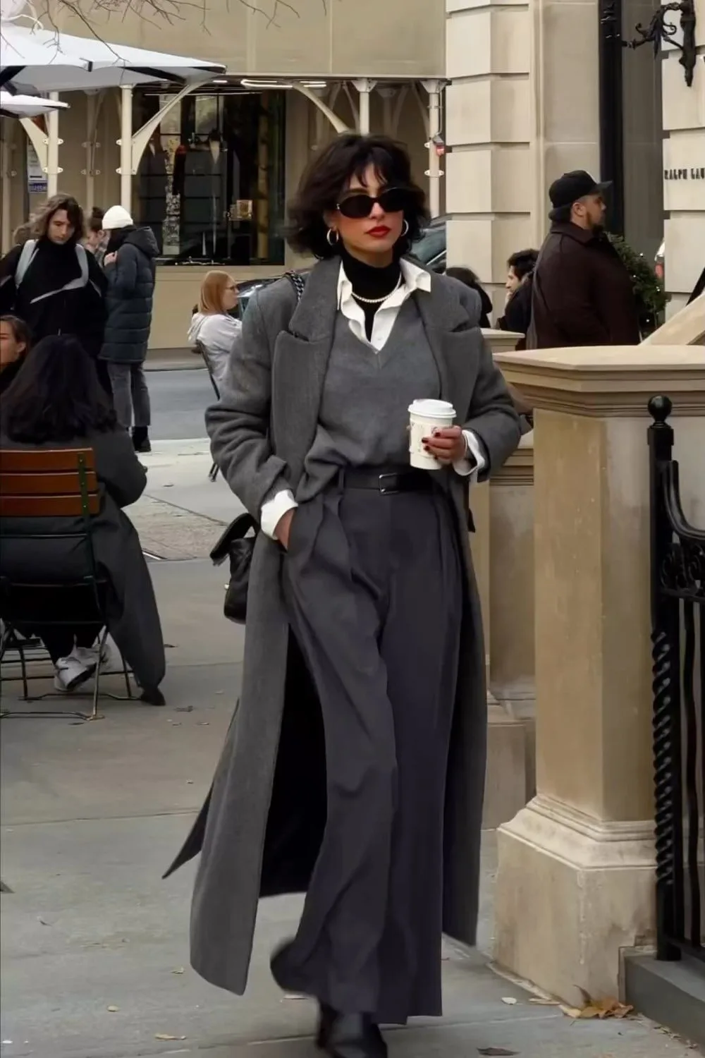 Grey coat over layered knit and trousers