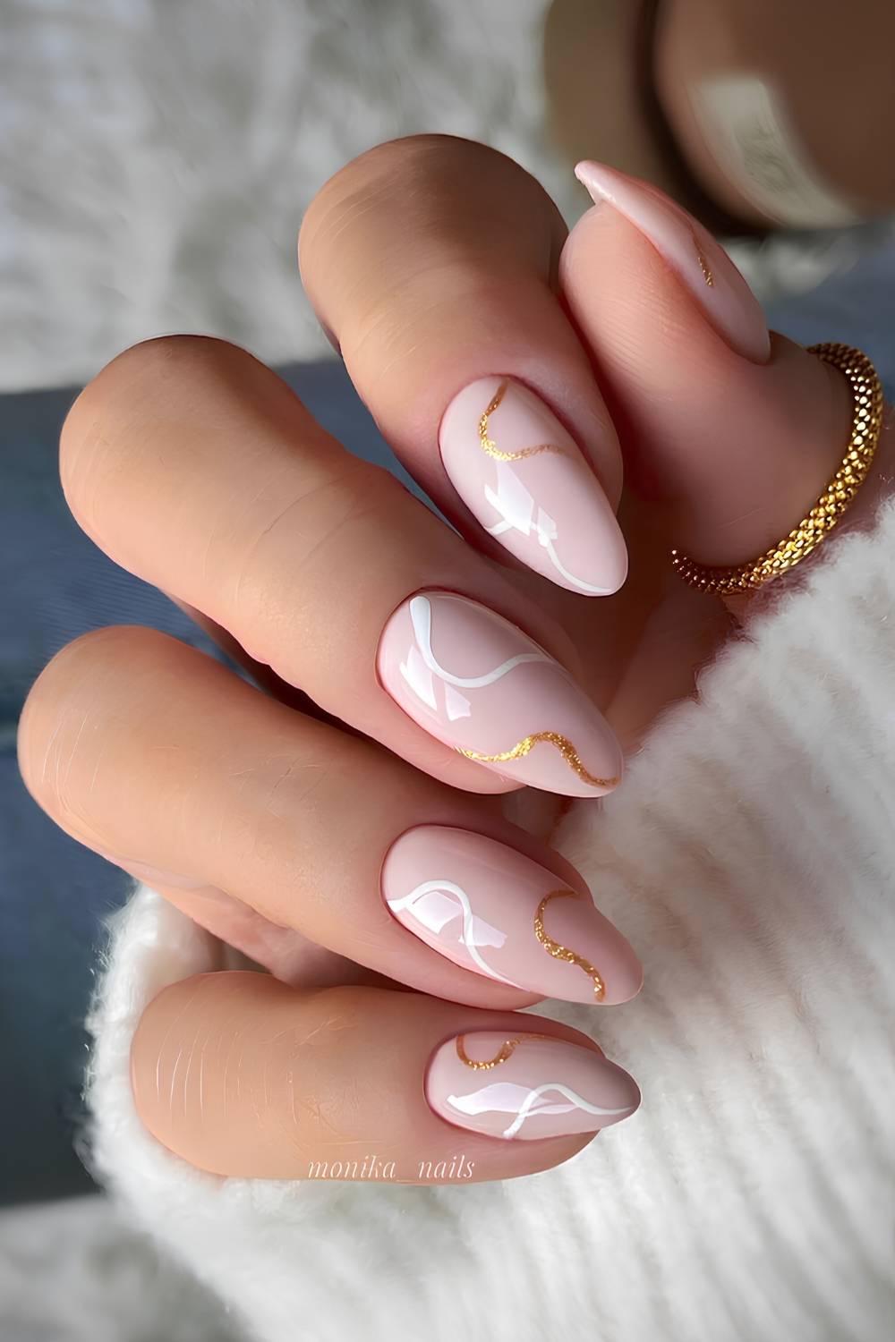 Light pink nails with white and glitter swirls