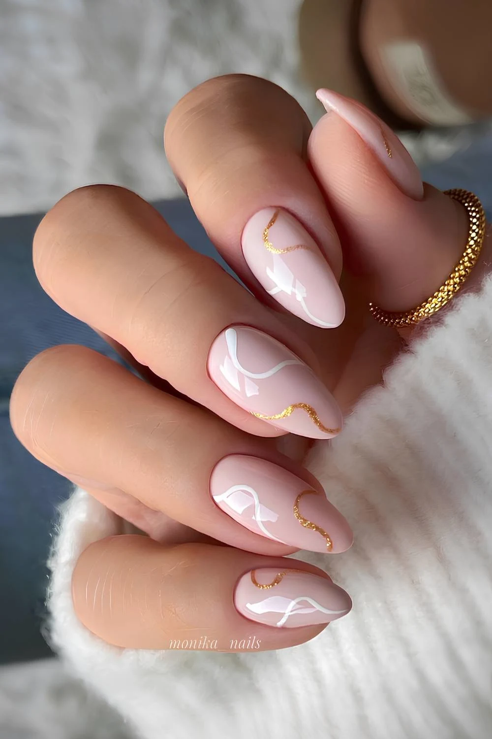 Light pink nails with white and glitter swirls
