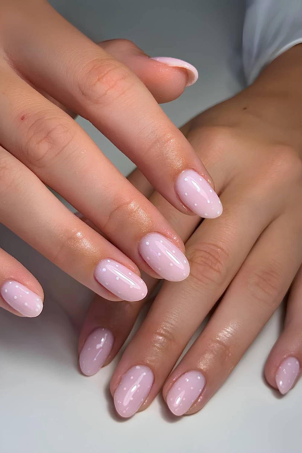 Milky pink manicure with polka dots
