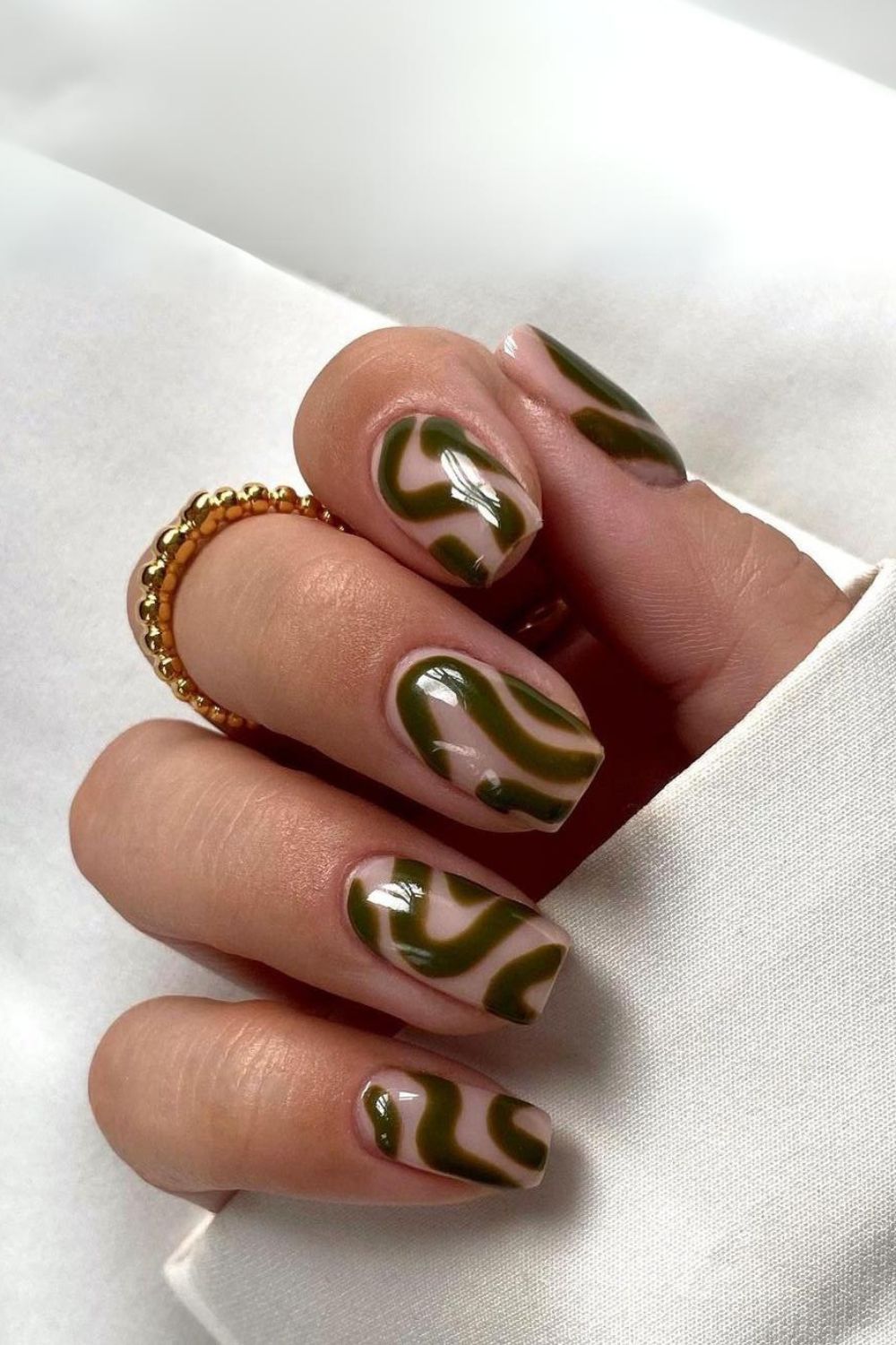 Nails with funky dark green swirls