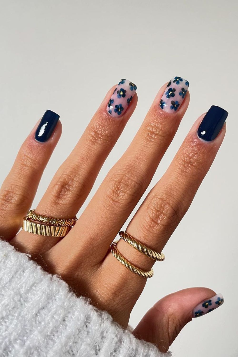 Navy blue and nude nails with floral design