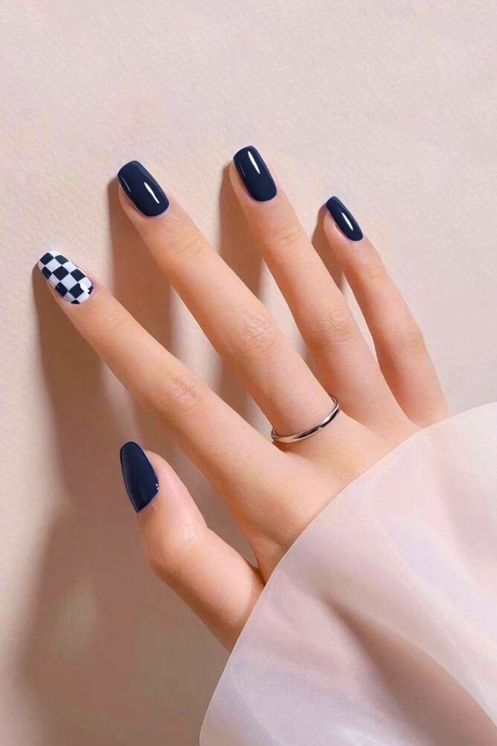 Navy nails with checkerboard accent nails