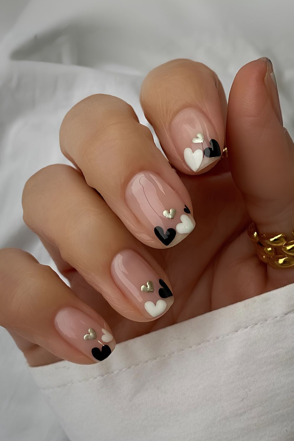 Neutral nails with black and white hearts