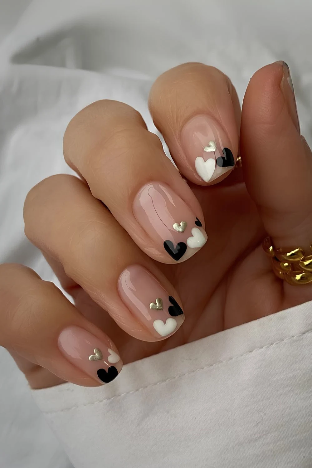Neutral nails with black and white hearts