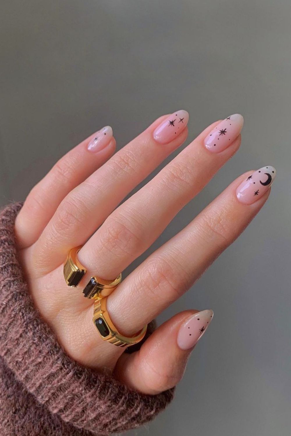 Nude manicure with black celestial accents