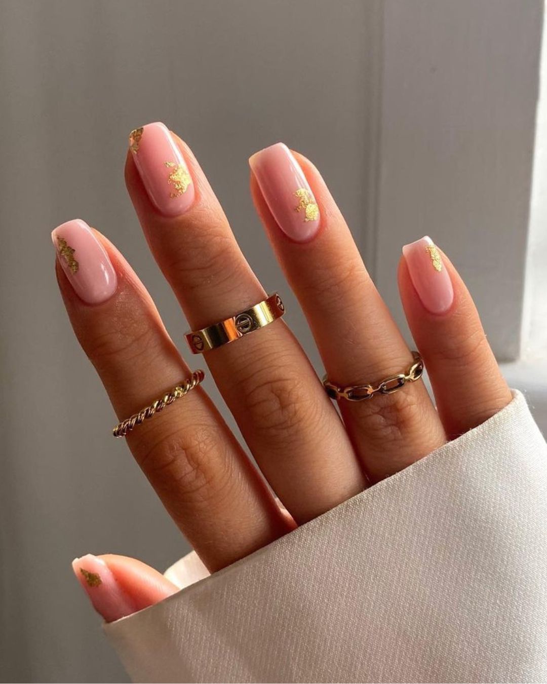 Nude manicure with golden foil accents