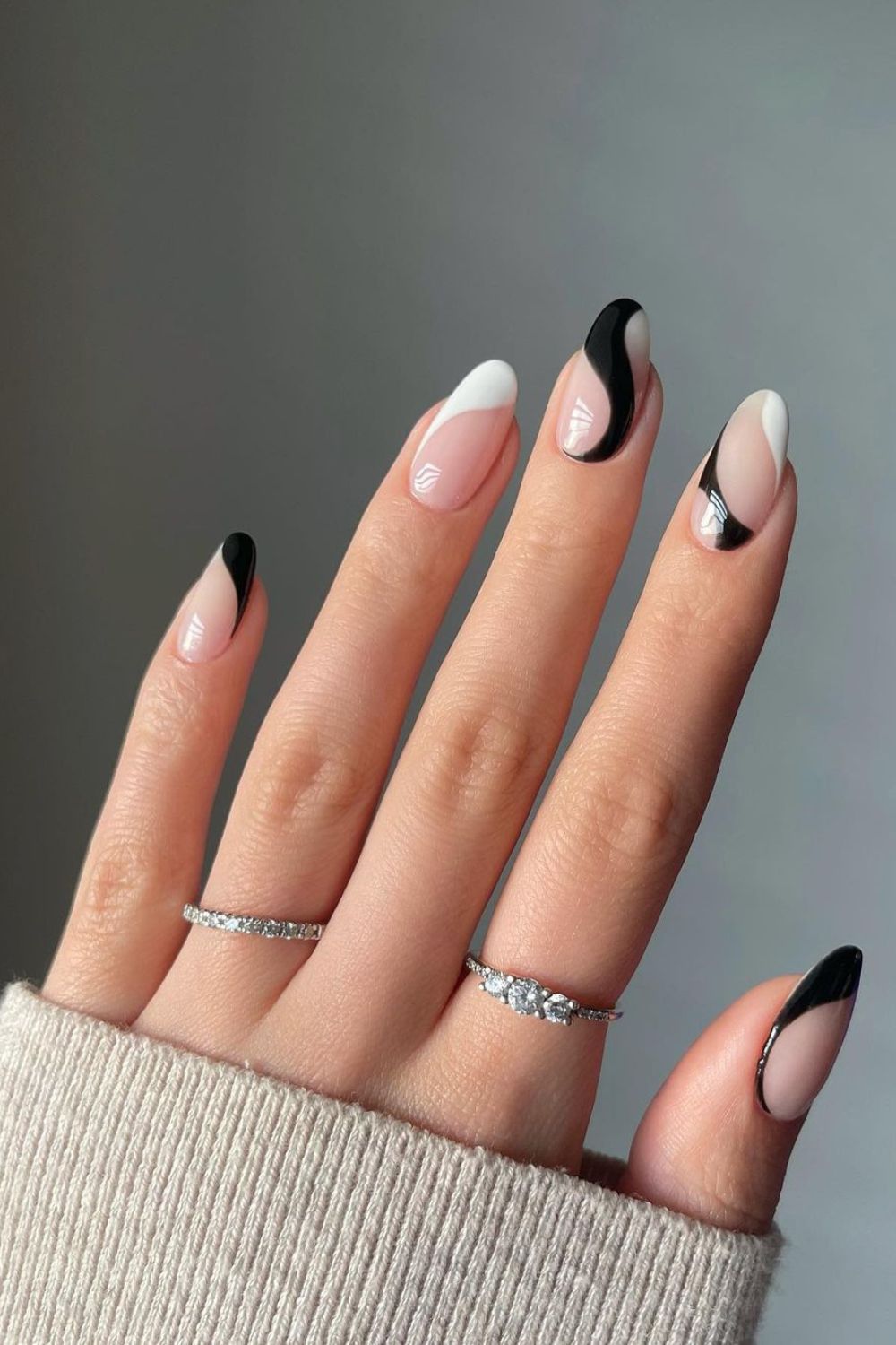 Nude nails with black and white swirls