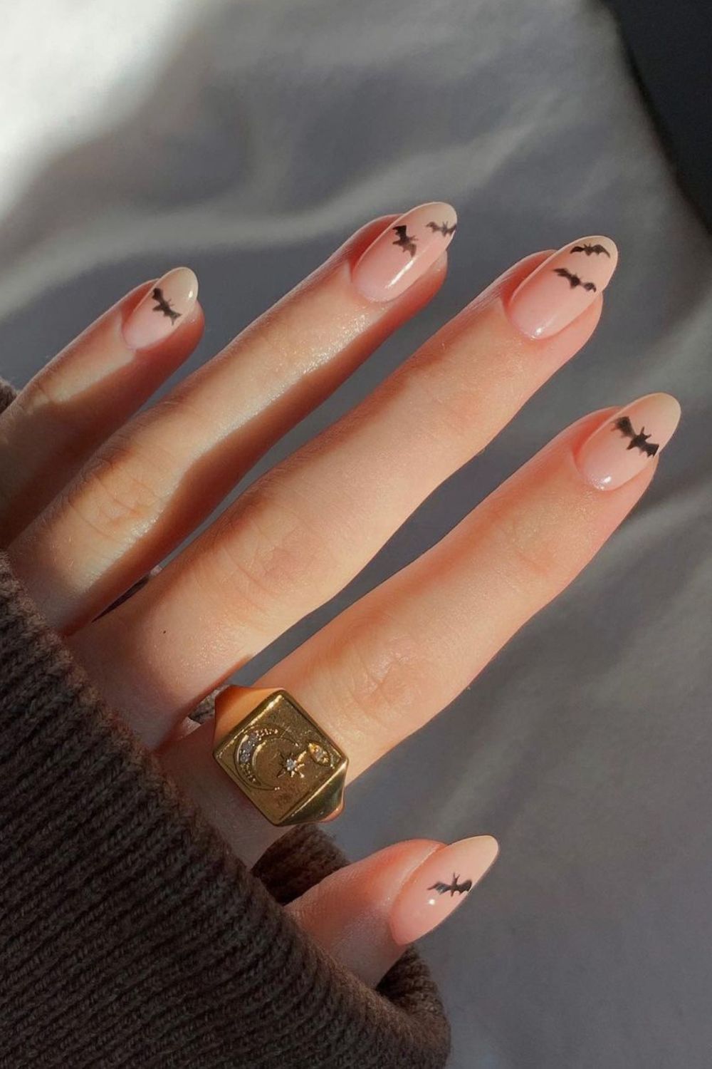 Nude nails with little bat designs