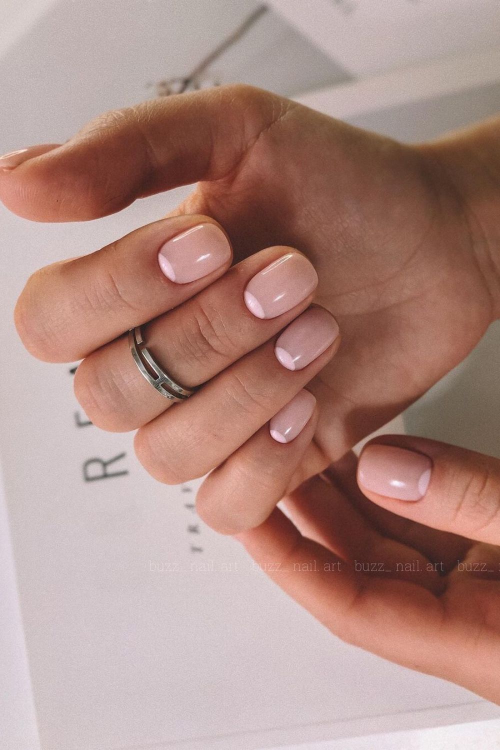 Nude nails with soft pink half moon accents