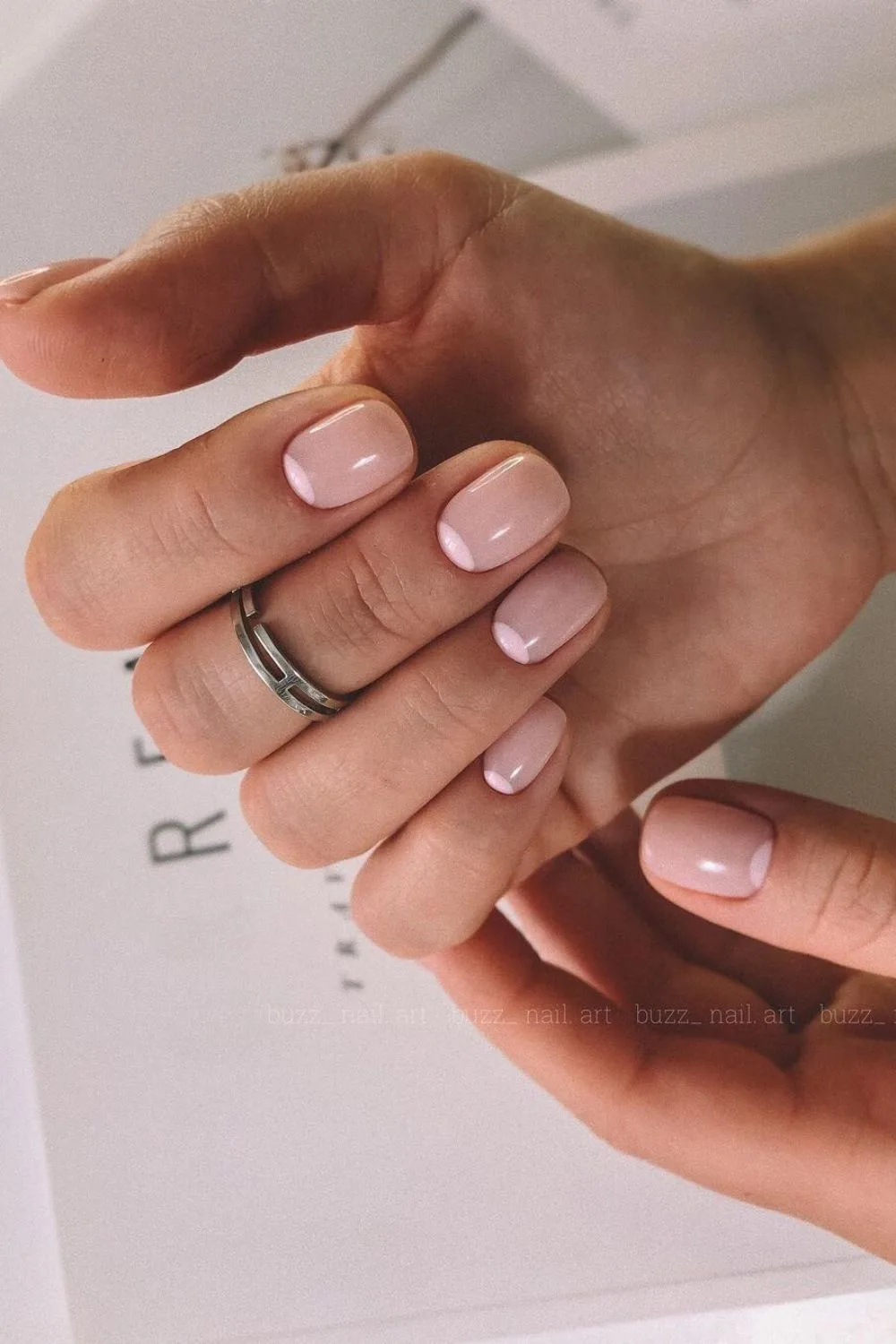 Nude nails with soft pink half moon accents