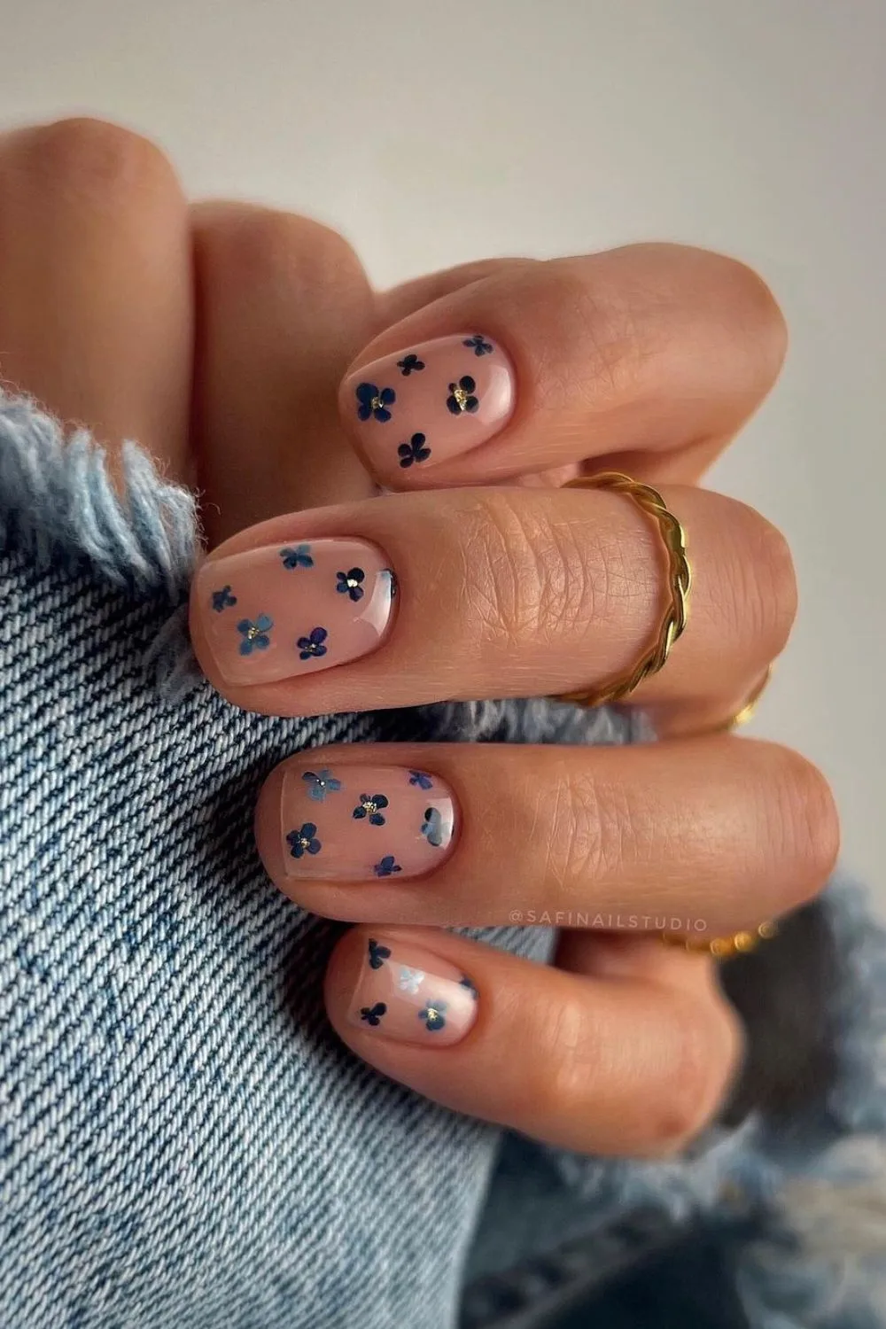 Nude nails with studded navy flowers