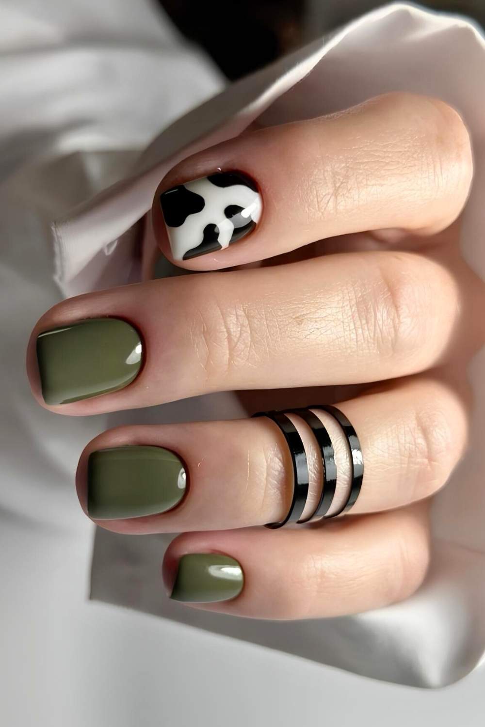 Olive green nails with accent cow print