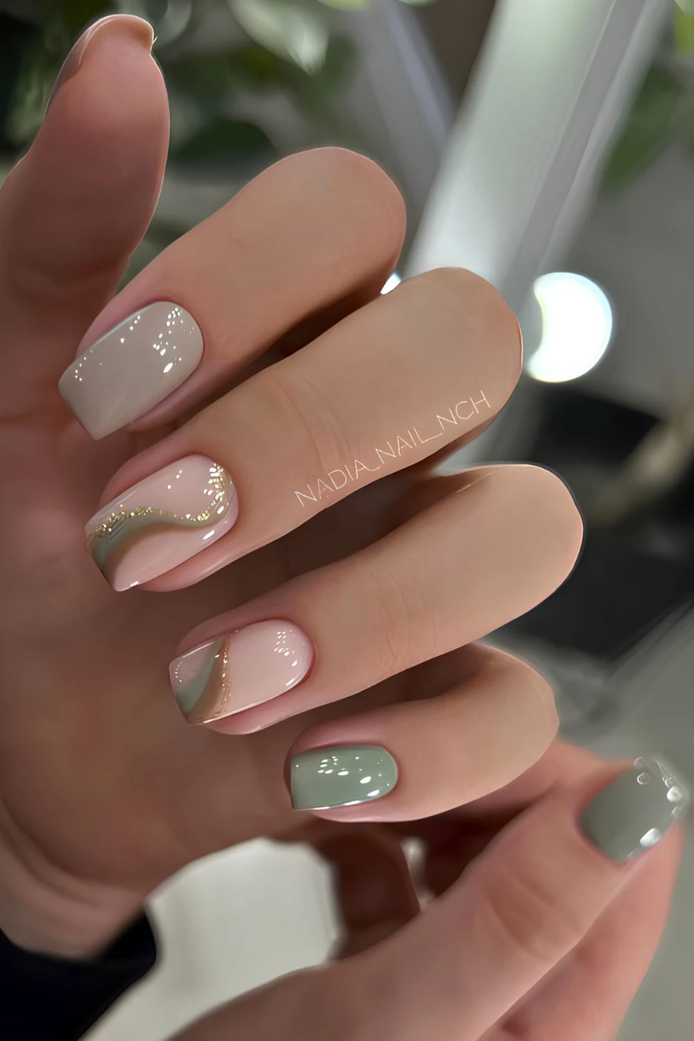 Sage green nails with swirl art