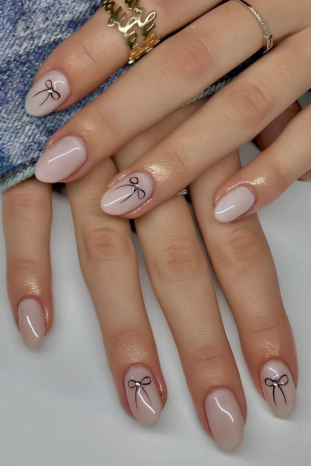 Sheer white nails with bow art