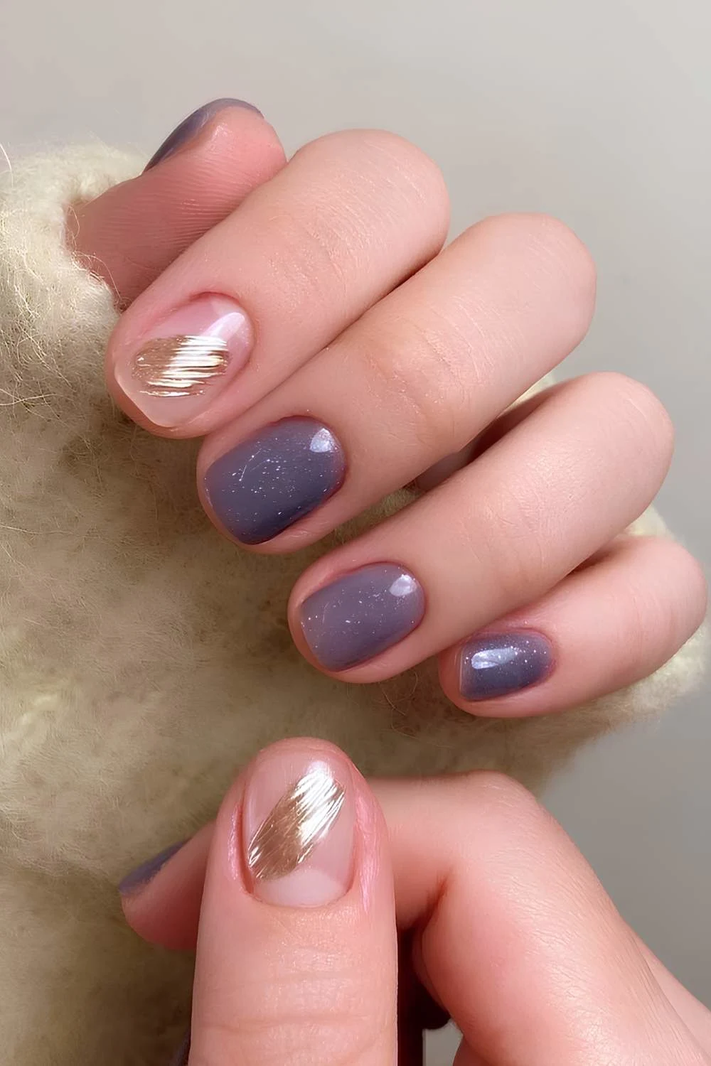 Shimmery purple nails with gold accents