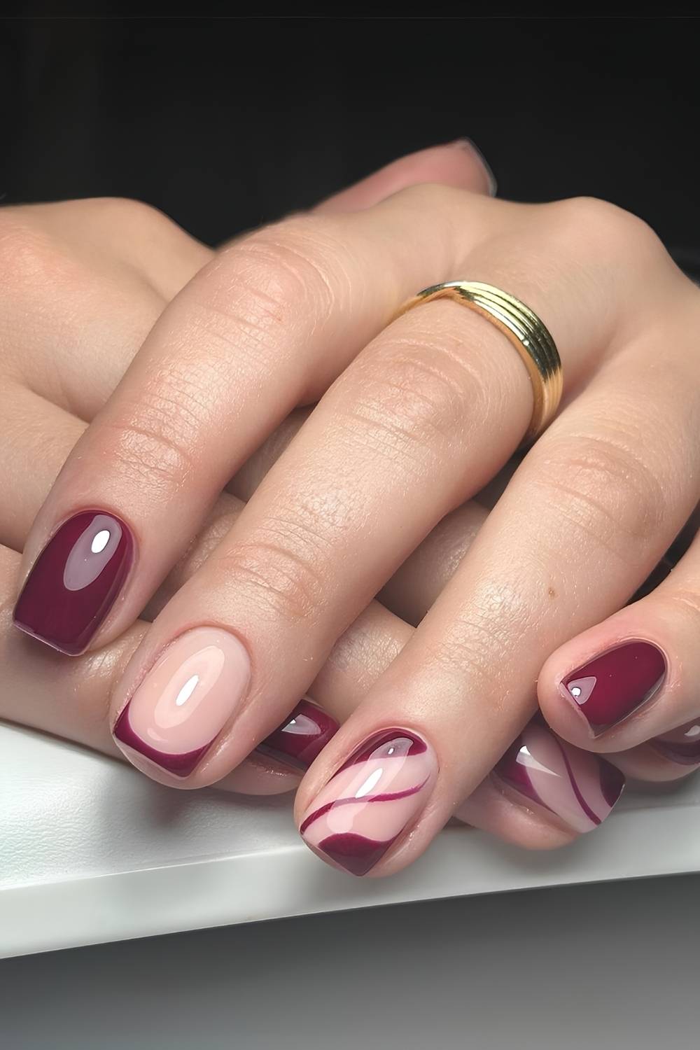 Short burgundy mani with negative space design