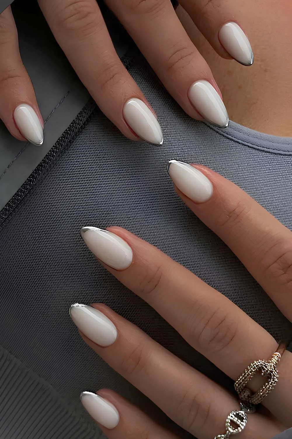 Silver French tip nails on a white base