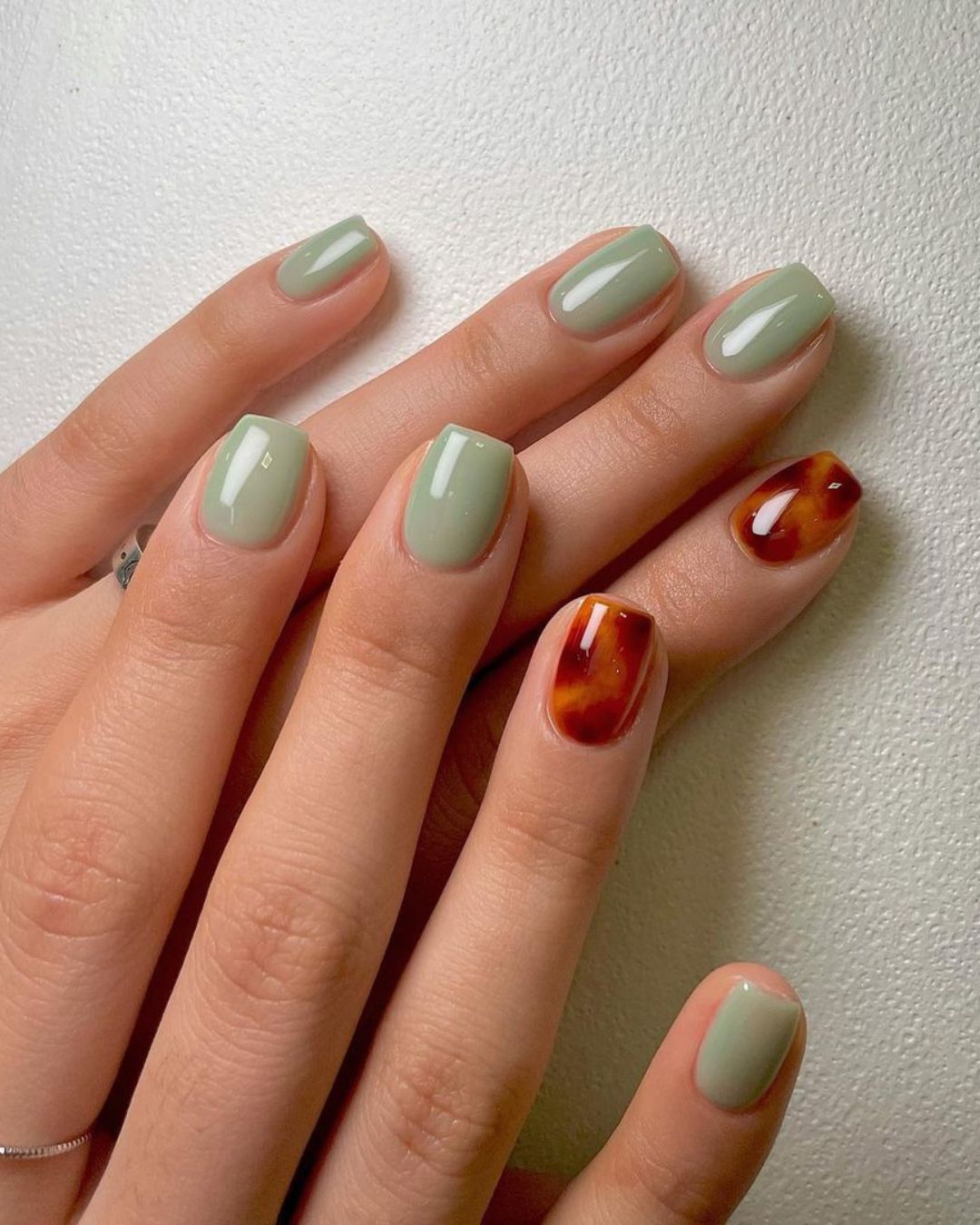 Soft green mani with tortoise shell accents