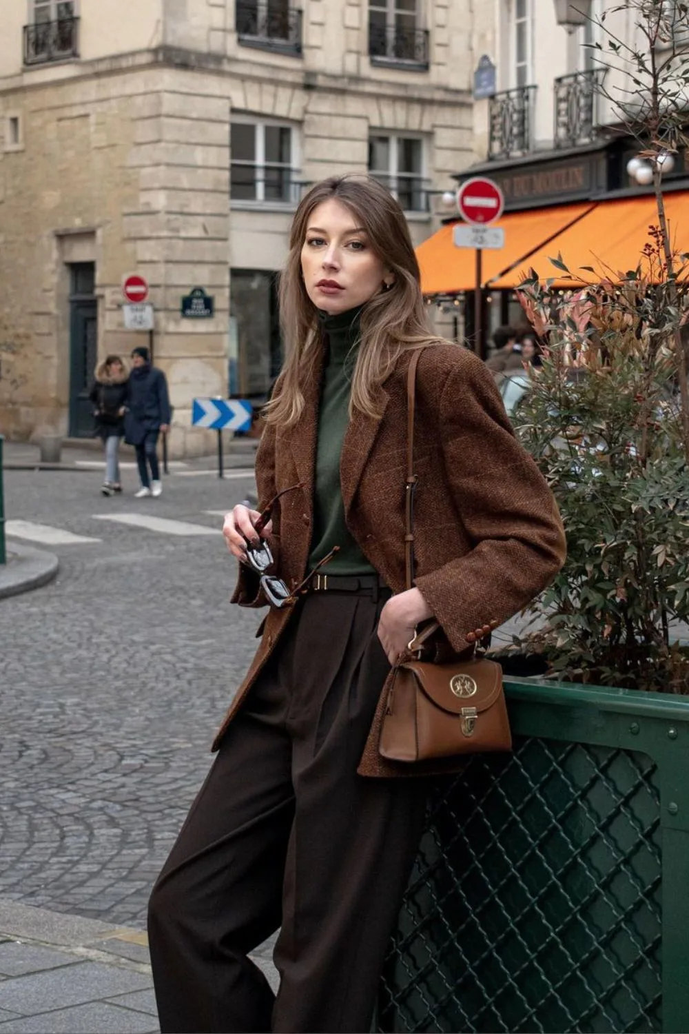 Tweed blazer over dark green turtleneck and wide-leg trousers