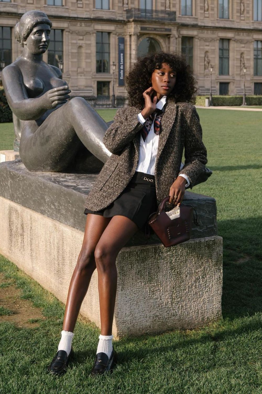 Tweed blazer over white shirt and mini skirt