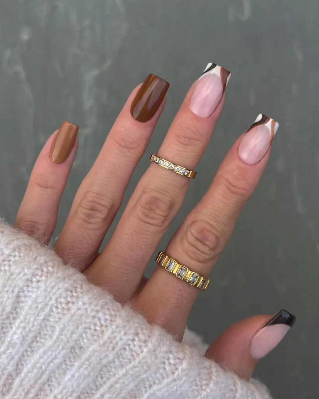 Two-shade brown nails with swirly accent tips