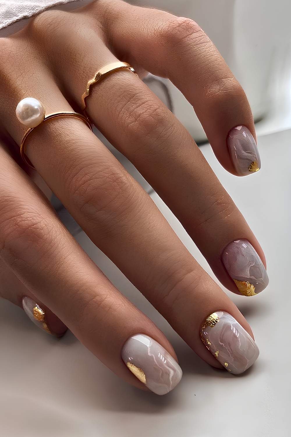 White marble manicure with gold foil accents
