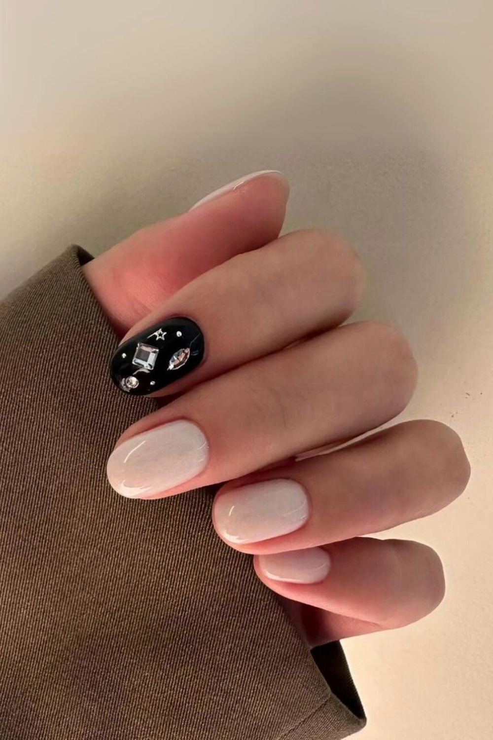 White nails with black and rhinestone accent