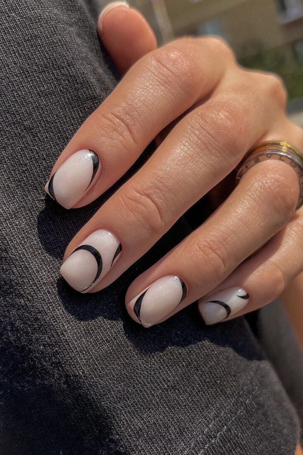 White nails with curved black lines