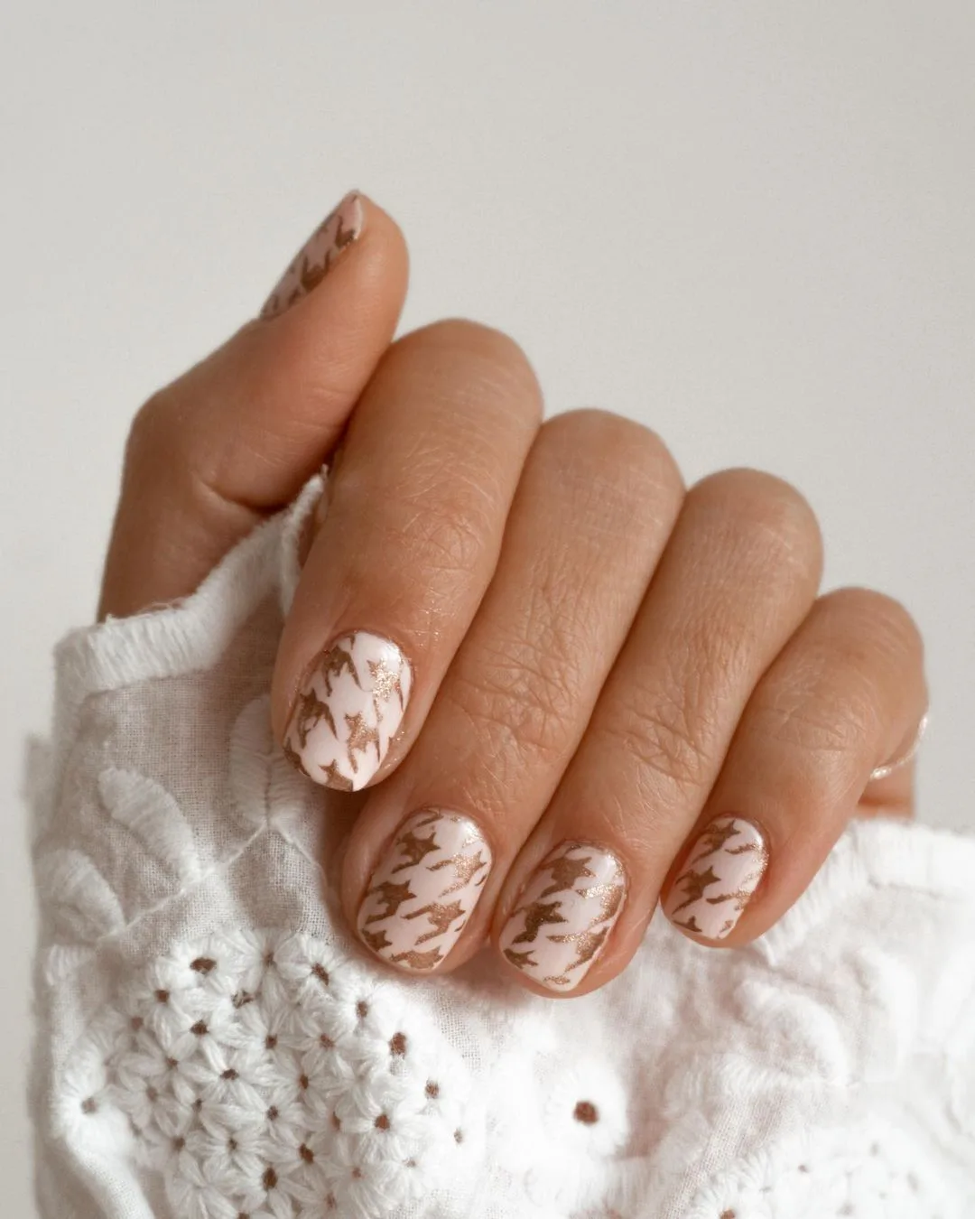 White nails with gold houndstooth accent