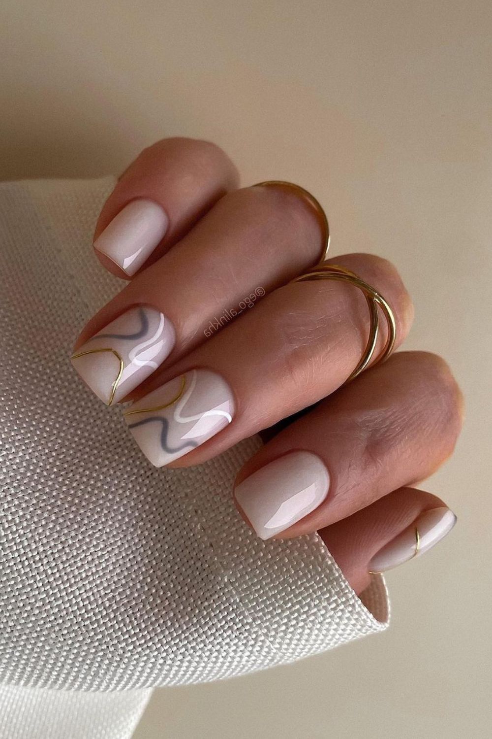 White nails with gray and gold lines