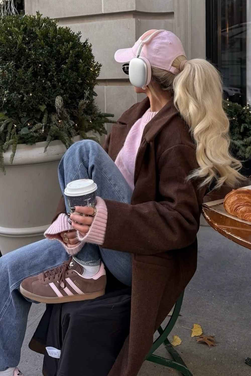 brown coat with pink sweater and pink cap