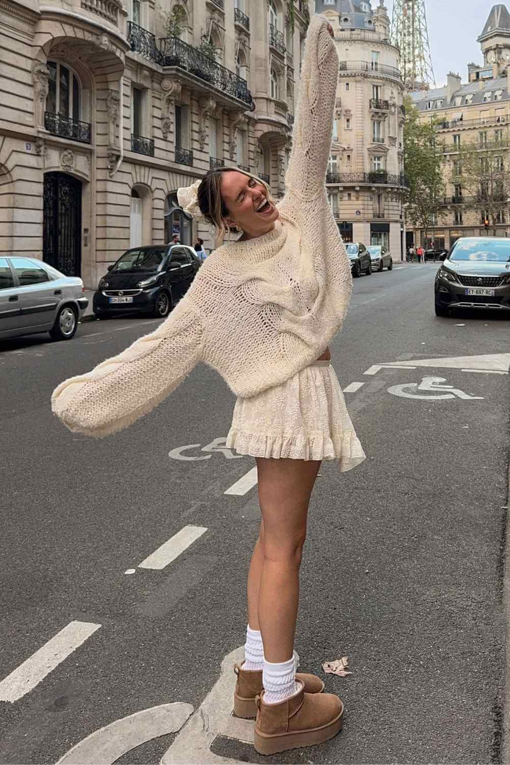 cream ruffle skirt with knit sweater and mini uggs