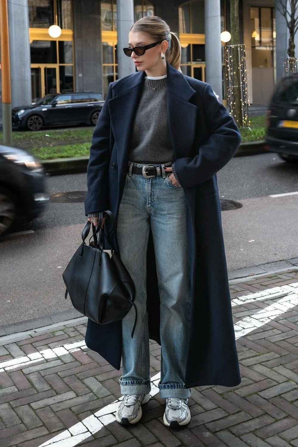 navy maxi coat with gray sweater and baggy jeans