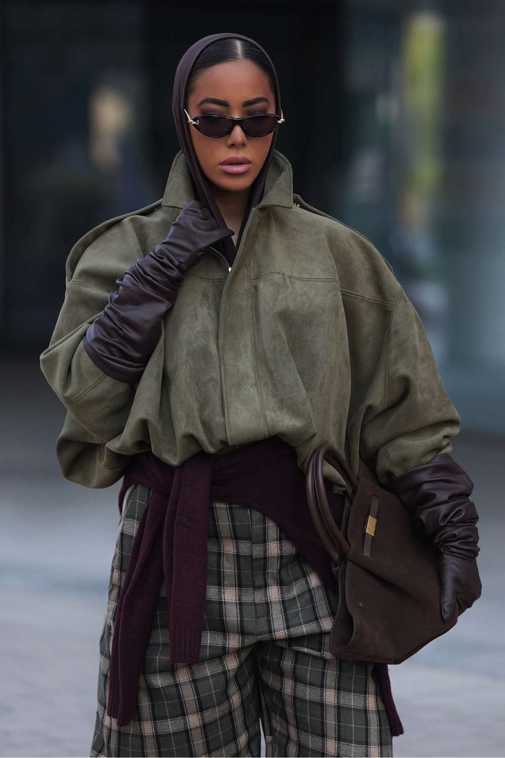olive suede jacket with gloves and plaid trousers
