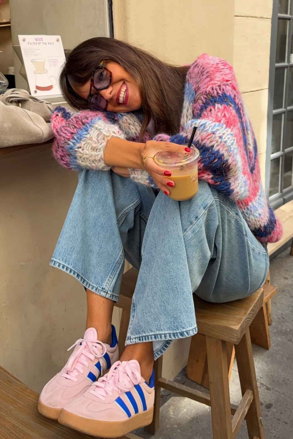 pink and blue chunky knit cardigan with jeans