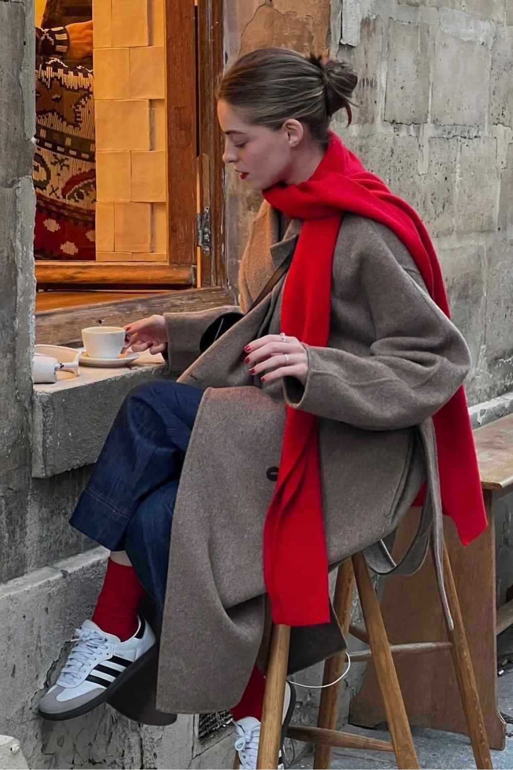 taupe wool coat with red scarf and red socks