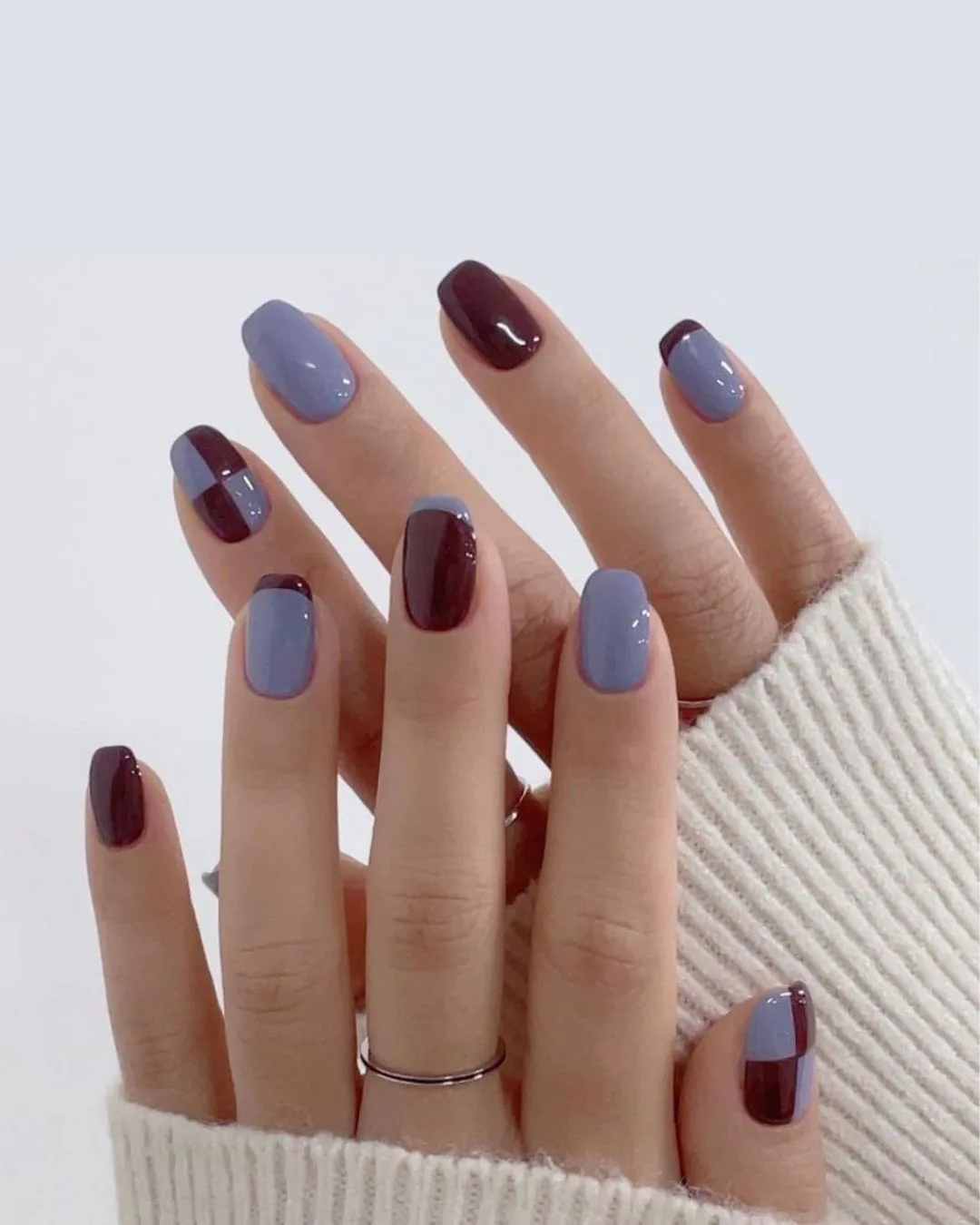 Blue and brown nails with checkerboard pattern