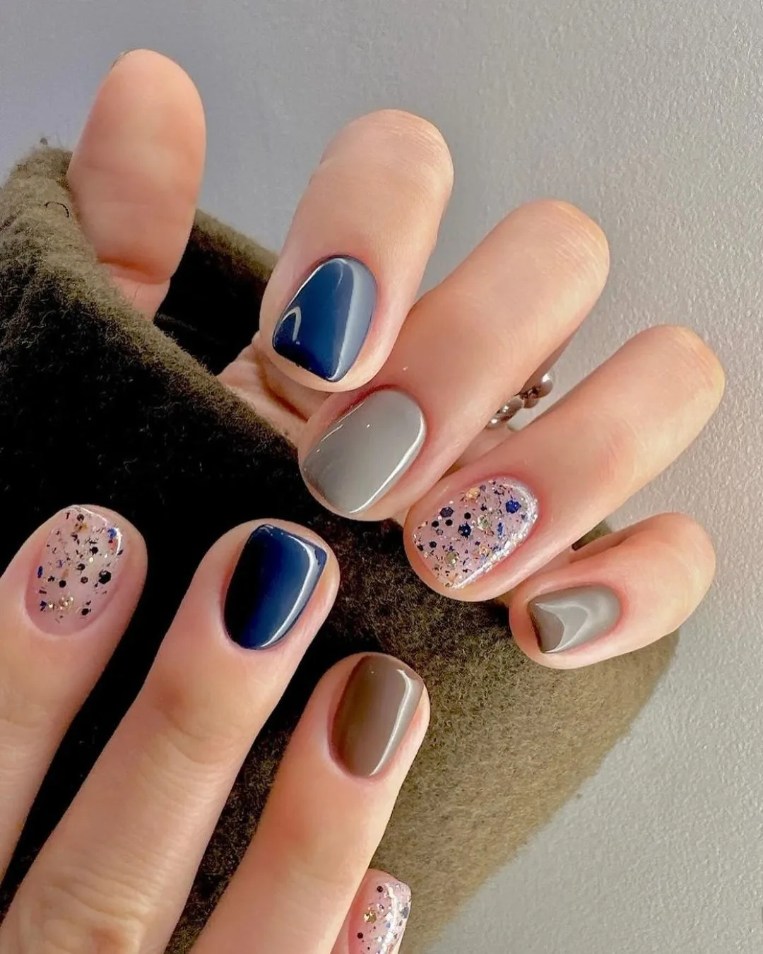 Blue and brown skittle nails with glitter accents