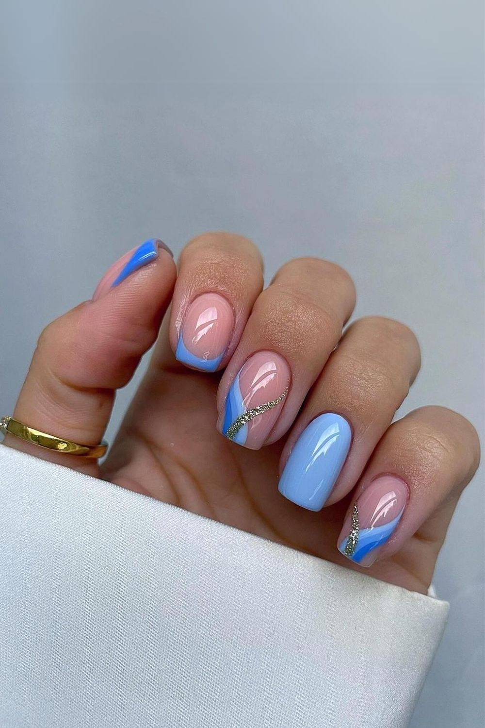 Blue nails with stripe and glitter accents