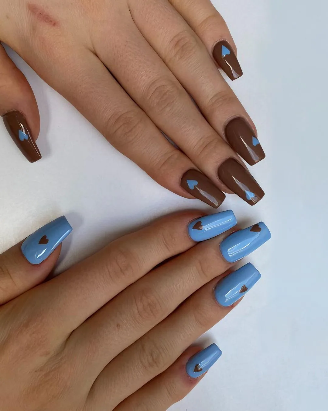 Brown and blue nails with heart accents