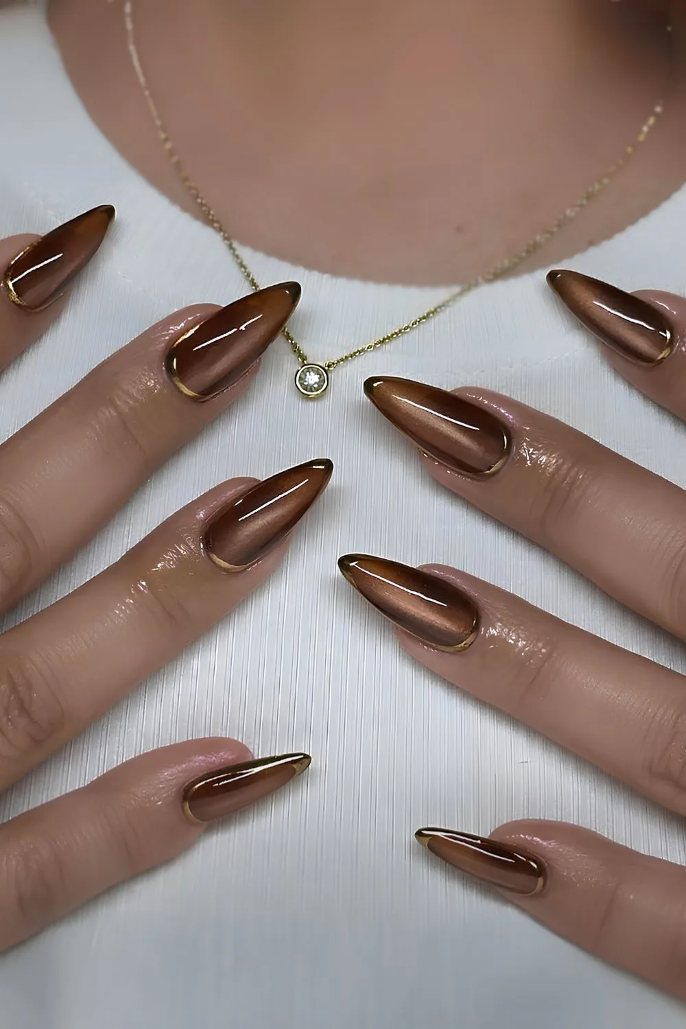 Brown cat eye nails with gold accents