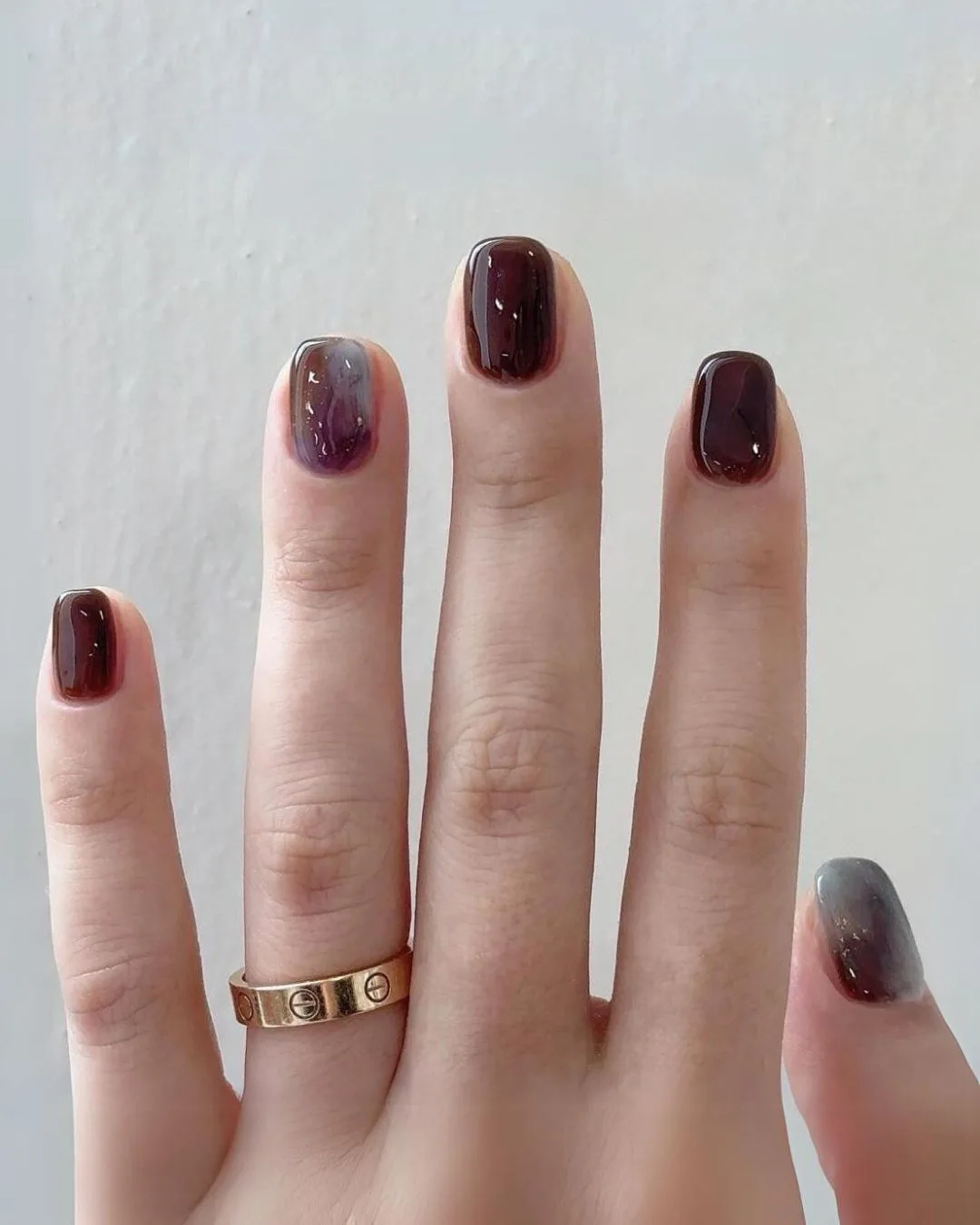 Brown nails with blue marble accents