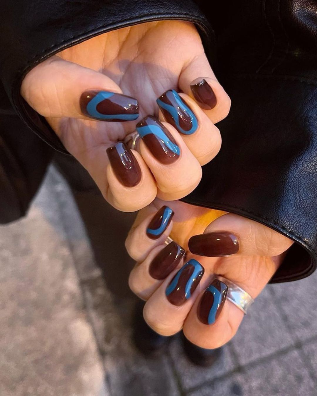 Brown nails with blue swirls