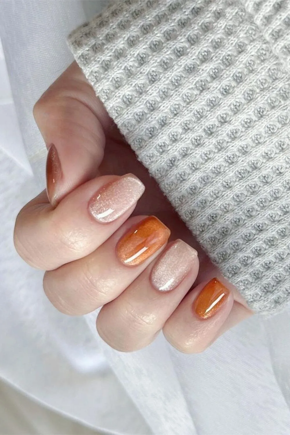 Burnt orange and white velvet-effect nails