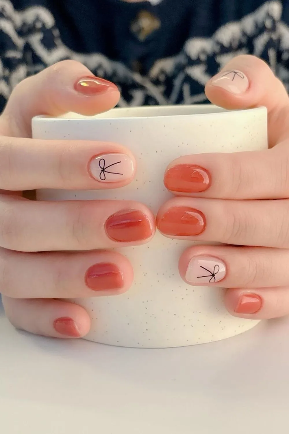 Burnt orange coquette nails with bows